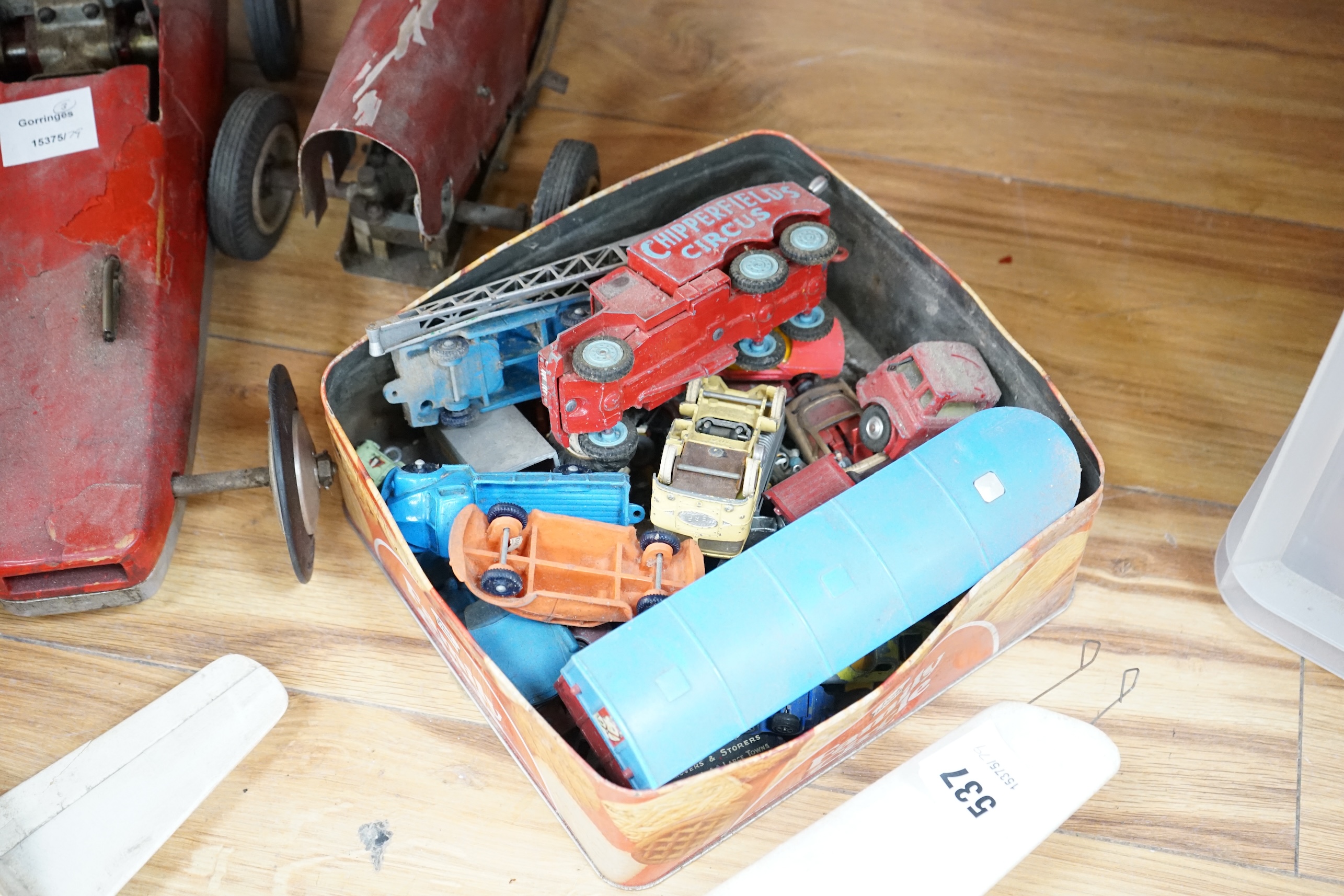 Two tinplate model racing cars, a model aeroplane, battleship and other various cars. Condition - poor